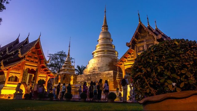 CHIANG MAI, THAILAND - NOVEMBER 20, 2018 : Unidentified tourists are traveling to Wat Phra Singh or Phra Singh temple in the twilight ,located in the old city centre of Chiang Mai Province ,Thailand,