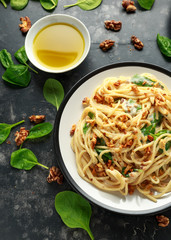 Pasta with roasted walnut, ricotta white pesto sauce, parmesan cheese and spinach