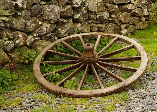 Old Wagon Wheel on a Farm Near a Stone Wall