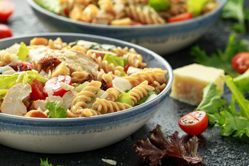 Caesar Salad Pasta with chicken, tomato, parmesan cheese and vegetables