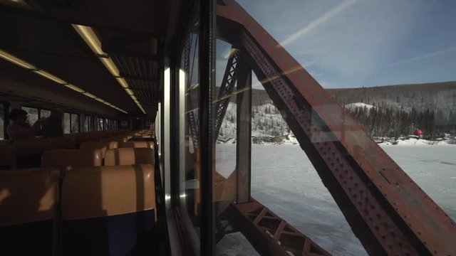 passing over a bridge on the alaska railroad train in winter