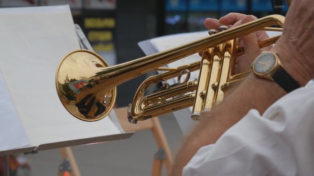 Close-up of hand playing trumpet. Brass instrument in a band