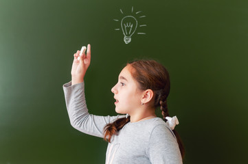 A schoolgirl at the blackboard was able to find a solution to the problem. inspiration. the idea came