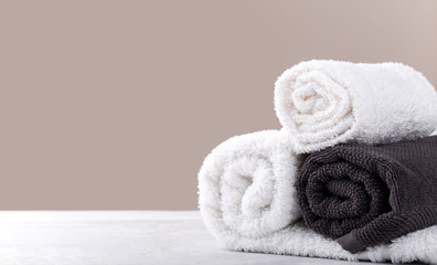 Fototapeta na wymiar White and beige soft rolled cotton towels