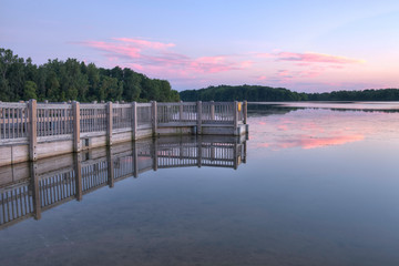 wooden pier on the lake at sunset