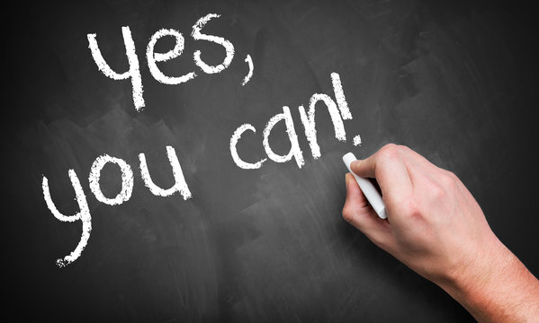 hand writing "yes, you can!" on a blackboard