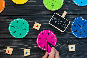 colorful math fractions on wooden background or table. interesting math for kids. Education, back to school concept. Geometry and mathematics materials.	
