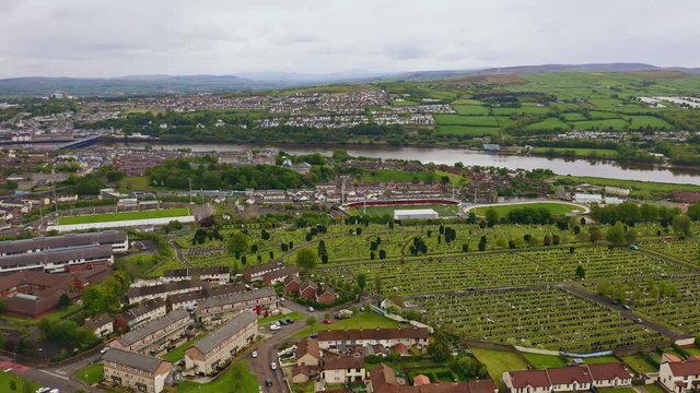 Aerial of Derry city, cemetery, farmlands and river foyle in Northern Ireland. PANNING SHOT