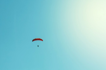 Paraglider and clear blue sky background