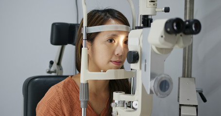 Woman undergo checking eye in clinic