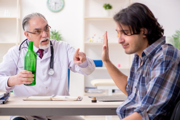 Young male alcoholic visiting old doctor