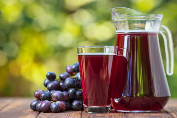 grape juice in glass and jug
