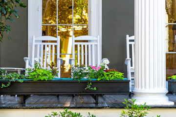 Old street historic Garden district in New Orleans, Louisiana with patio garden green plants...