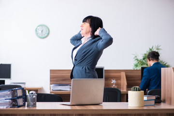 Two employees doing sport exercises in the office