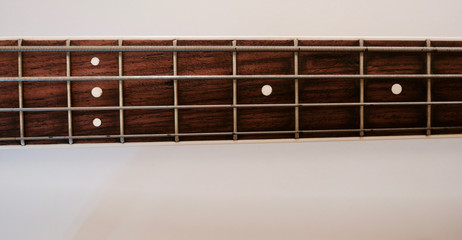 bass guitar neck . color background. closeup