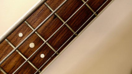 bass guitar neck . color background. closeup