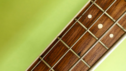 bass guitar neck . color background. closeup