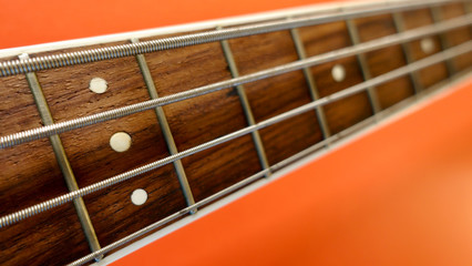 bass guitar neck . color background. closeup