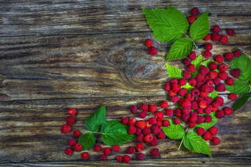 Fresh organic fruit - raspberry on wood background.