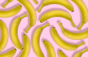 Banana collage. Chilled fruits out of the fridge with condensate droplets. Pink background. Juicy yellow berry. Delicious banan.