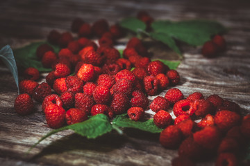 Fresh organic fruit - raspberry on wood background selective focus.