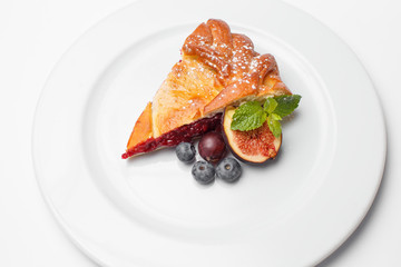 pie slice with a berry and a figs