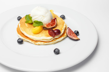 pancakes with ice cream and a berries