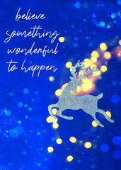 Obraz na płótnie Canvas believe something wonderful to happen. toy reindeer in abstract blue glitter background. decor christmas Silver deer. new year, Christmas holiday season. soft selective focus, shallow depth