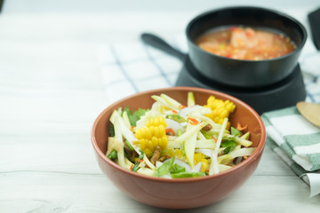 Spicy slice mango salad served with salmon