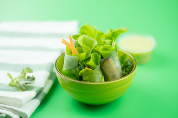 Salad roll on green bowl