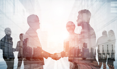 Double exposure image of many business people conference group meeting on city office building in...