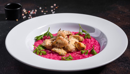 Delicious risotto with roasted pieces of chicken fillet. Risotto with chicken pieces. 