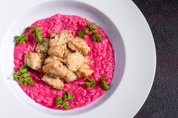 Delicious risotto with roasted pieces of chicken fillet. Risotto with chicken pieces. 
