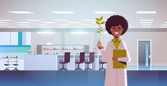 female scientist examining plant sample in test tube african american woman making experiment chemical research science concept modern genetic lab interior horizontal portrait