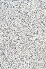 Gray wall with black spots and vertical scratches.