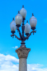 Fototapeta na wymiar Street lamp against the blue sky on a summer day.