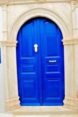 Fototapeta na wymiar Traditional wooden door in blue color, in Tinos island, Cyclades, Greece.