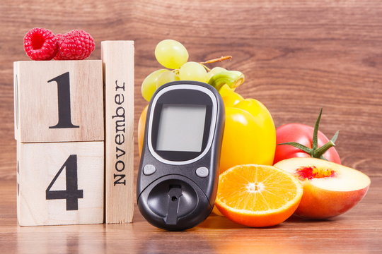 Date 14 November as symbol of world diabetes day, glucometer for measuring sugar level and fruits with vegetables