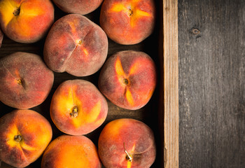 Sweet ripe peaches on the rustic background. Selective focus. Shallow depth of field.