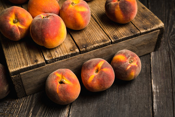 Sweet ripe peaches on the rustic background. Selective focus. Shallow depth of field.