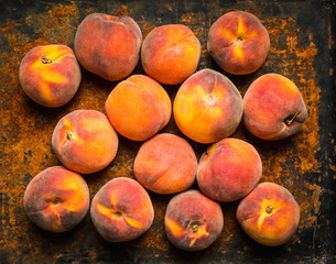 Sweet ripe peaches on the rustic background. Selective focus. Shallow depth of field.