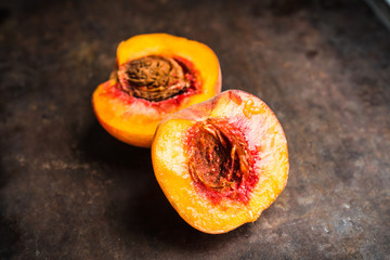 Sweet ripe peaches on the rustic background. Selective focus. Shallow depth of field.