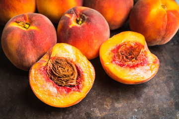 Naklejka na ściany i meble Sweet ripe peaches on the rustic background. Selective focus. Shallow depth of field.