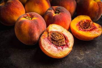 Sweet ripe peaches on the rustic background. Selective focus. Shallow depth of field.