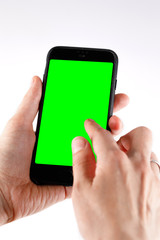 Touch screen smartphone in a hand.Man holding smartphone with blank screen on white background, closeup of hand. Space for text.