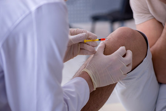 Male patient visitng doctor for shot inoculation