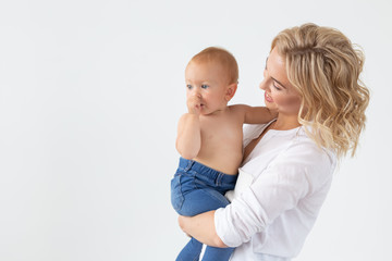Happy mother with adorable baby on white background with copy space