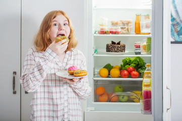 teenager girl at fridge with food