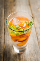 Gin based cocktail with peaches and thyme. Selective focus. Shallow depth of field.