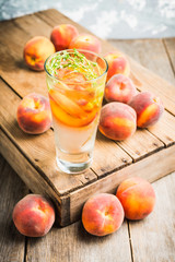 Gin based cocktail with peaches and thyme. Selective focus. Shallow depth of field.
